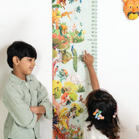 Two children standing next to a colorful growth chart with animal designs Zookeeper