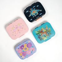 Four colorful small cases with animal and floral designs