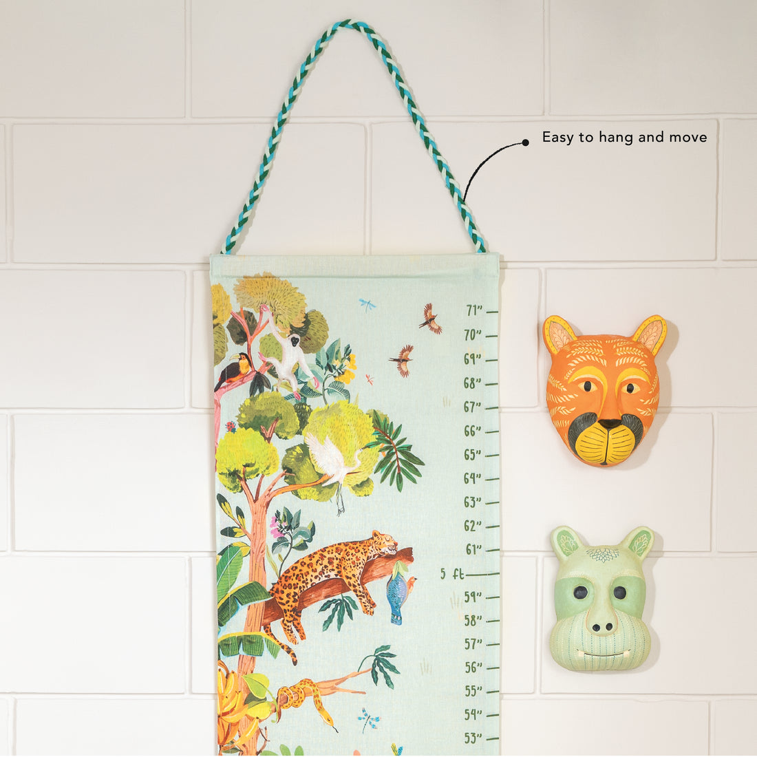 Children's growth chart with jungle design and animal-themed wall decor on a tiled wall