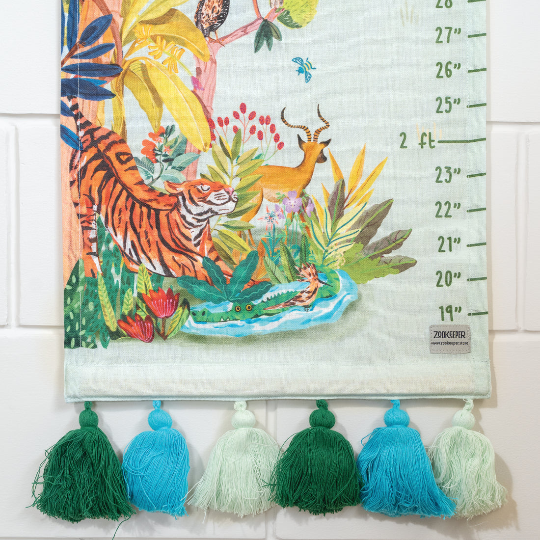Children's growth chart with jungle-themed illustration and colorful tassels