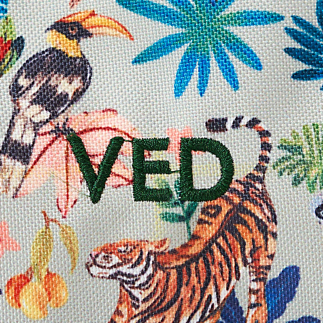 Tropical fabric with a tiger, toucan, and leaves, featuring the brand 'VED'.