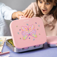 Pink lunch box with butterfly design held by a child, with another person partially visible.